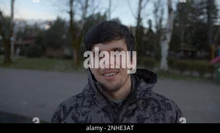 Man in a coat conducting a point of view video conference call outdoors Stock Photo