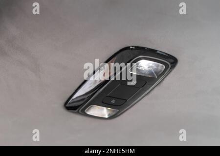Car ceiling lamp in a car. Modern car interior lights close-up. Stock Photo