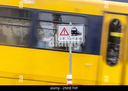 Unrestricted level crossing, St. Andrews cross with warning light and a passing light railway OeNVP, Stuttgart, Baden-Wuerttemberg Stock Photo