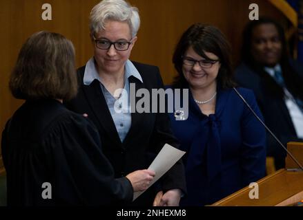 Tina Kotek, center, was accompanied by her wife Aimee Wilson, right, as