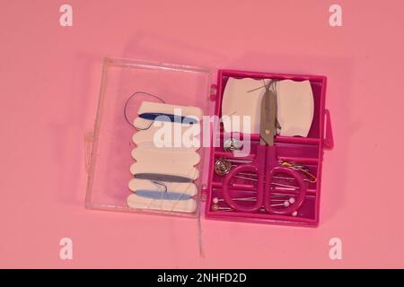 Mini sewing kit on a pink background Stock Photo