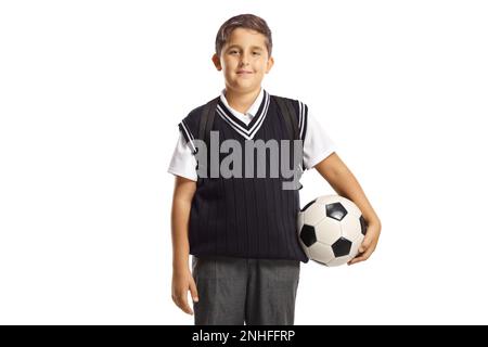 Schoolboy wearing a school uniform and holding a football isolated on white background Stock Photo
