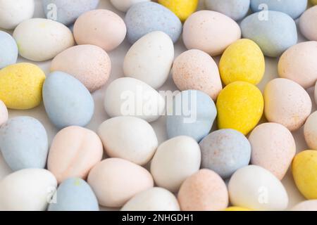 Blue, yellow, pink, and white pastel candy coated chocolate Easter eggs. Stock Photo