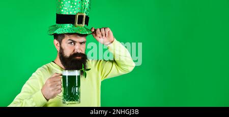 Patricks Day pab party. Bearded man in leprechaun hat with green beer. Bearded in green hat drinking green beer. Irish tradition. Patricks Day man in Stock Photo