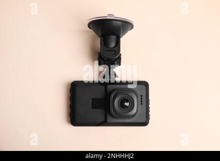 Modern car dashboard camera with suction mount on light pink background, top view Stock Photo