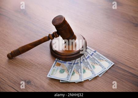 Judge's gavel and dollar bills on wooden table Stock Photo