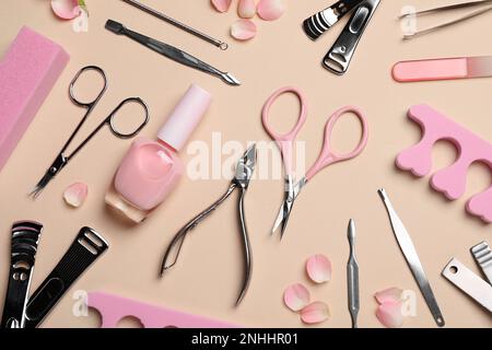 Composition with manicure and pedicure tools on beige background, flat lay Stock Photo