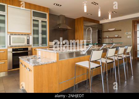 Modern Kitchen With Rich Wood Cabinets & Black Granite Counter Stock ...