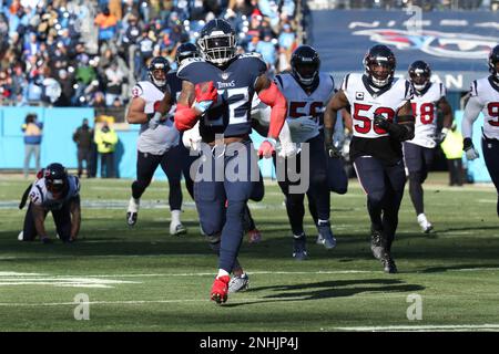 NASHVILLE, TN - DECEMBER 24: Tennessee Titans running back Derrick Henry  (22) stiff arms Houston Texans safety Jalen Pitre (5) during a game between  the Tennessee Titans and the Houston Texans, December