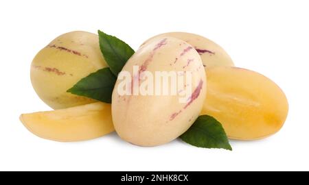 Whole and cut pepino melons with green leaves isolated on white Stock Photo