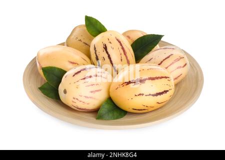 Plate with fresh ripe pepino melons and green leaves on white background Stock Photo