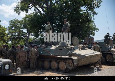 Bulgarian soldiers assigned to 42nd Mechanized Battalion, 2nd Mechanized Brigade demonstrate the operation of the MT-LB multipurpose fighting vehicle to U.S. Soldiers assigned to 4th Infantry Division and 4th Security Force Assistance Brigade, and British Army soldiers assigned to 16th Air Assault Brigade Combat Team in attendance at the multinational vehicle static display during Exercise Platinum Lion 2022, Novo Selo Training Area, Bulgaria, July 30, 2022. Exercise Platinum Lion is a battalion-level event designed to provide quality, organized and realistic training for designated military u Stock Photo