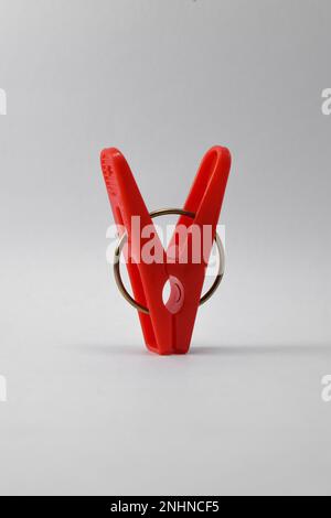 Red plastic clothespin isolated on white background. Plastic clips Stock Photo