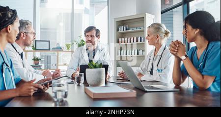 Meeting, team and doctors in discussion in the hospital conference room for collaboration. Teamwork, medical and group of healthcare workers talking Stock Photo