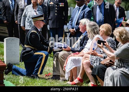 The U.S. flag is presented to Peter Esmay following the funeral service of Esmay's uncle, U.S. Army 1st Lt. Myles W. Esmay, in Section 36 of Arlington National Cemetery, Arlington, Va., Aug. 1, 2022. 1st Lt. Esmay was killed on June 7, 1944 during the siege of Myitkyina, Burma in World War II.  From the Defense POW/MIA Accounting Agency (DPAA) press release:  In the spring and summer of 1944, 1st Lt. Esmay, an infantry engineer, was a member of Company B, 236th Engineer Combat Battalion, reinforcing the 5307th Composite Unit (Provisional), also known as Merrill’s Marauders. Esmay’s battalion a Stock Photo