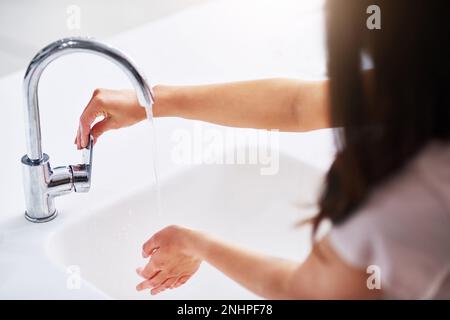 Living a germ-free lifestyle. Closeup shot of an unrecognizable woman washing her hands. Stock Photo