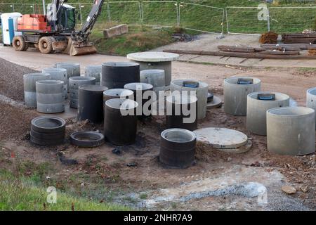 New  concrete rings for wells and sewer on construction  site Stock Photo