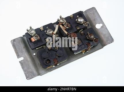 Old broken retro voltage switch buck side  isolated on white Stock Photo