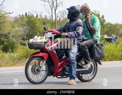 BANGKOK, THAILAND, FEB 07 2023, A two mens rides on motorcycle Stock Photo
