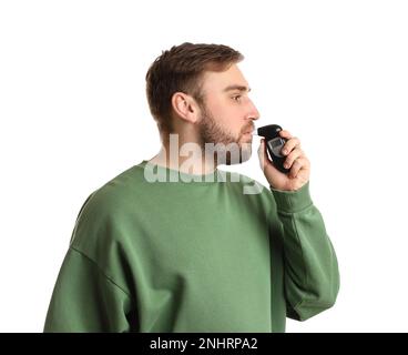 Man blowing into breathalyzer on white background Stock Photo