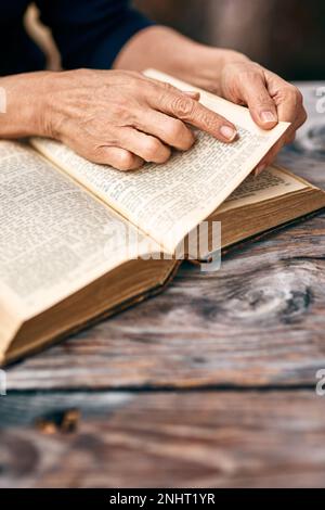Taking in every word. an unrecognizable woman reading a book. Stock Photo
