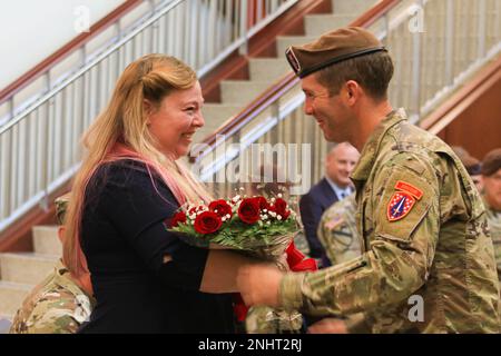 Mrs. Heather A. Teakell, spouse of Command Sgt. Maj. Reese W. Teakell outgoing Command Sergeant Major of the Security Force Assistance Command, receives a bouquet of red roses during a Change of Responsibility ceremony at Fort Bragg, N.C., Aug. 2, 2022. The presentation of roses is a tradition that symbolizes transition and a new beginning for relationship between the command and it's Soldiers and Families. Stock Photo