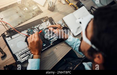 Hardware, engineering and IT professional repair motherboard, microcircuit or electronic device in a workshop or shop. Overhead, man and guy fixing a Stock Photo