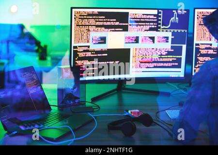 Developer, code or computer screen in neon programming, cybersecurity ransomware or SEO night phishing in basement. Hacker, programmer or woman on Stock Photo