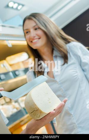 Woman asking for cheese advice Stock Photo