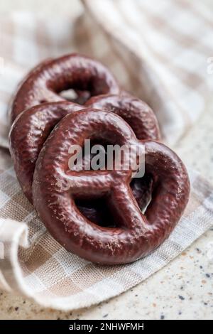 Sweet chocolate pretzels on the checkered napkin. Stock Photo