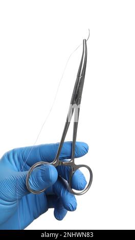 Doctor holding forceps with suture thread on white background, closeup. Medical equipment Stock Photo