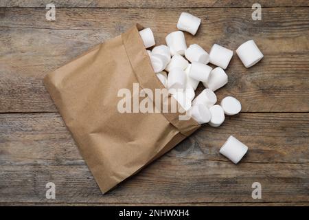 Delicious puffy marshmallows on wooden table, flat lay Stock Photo