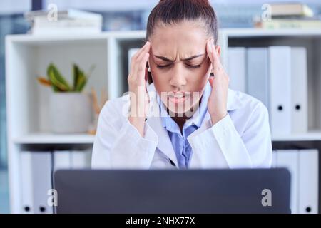 Burnout, stress and doctor with a headache from a laptop, healthcare anxiety and depression. Medicine, angry and nursing woman with a migraine, mental Stock Photo