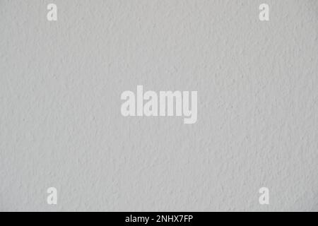 White wallpaper with rugged surface close up observed and used as background with copy space. Stock Photo