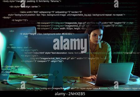 Programmer working in modern office at night Stock Photo