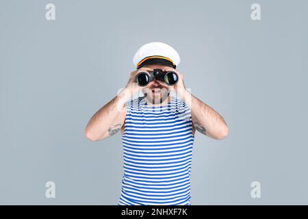 Sailor with binoculars on light grey background Stock Photo - Alamy