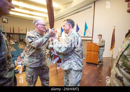 The U.S. Army Research Institute of Environmental Medicine held a Change of Command ceremony at the Natick Soldier Systems Center's Hunter Auditorium, August 3. As part of traditional protocol, incoming USARIEM commander, Col. Michael I. Cohen (right), received the USARIEM guidon from Brig. Gen. Anthony L. McQueen (left), commanding general of the U.S. Army Medical Research and Development Command and Fort Detrick. (Photo by Davis Kamm, DEVCOM SC) Stock Photo