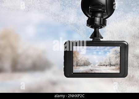 Modern dashboard camera mounted in car, view of road during driving Stock Photo