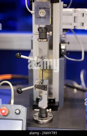 Electromechanical single column materials testing system during tensile strength test. Selective focus. Stock Photo