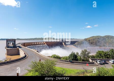 Gariepdam, South Africa - Feb 21, 2022: The largest dam in South Africa, the Gariep Dam, overflowing. It is in the Orange River. People and vehicles a Stock Photo