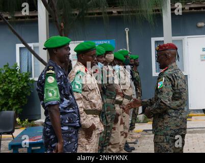 Members of African Union Transition Mission in Somalia (ATMIS) greet Brig. Gen. Tahir Ali Mohamed, headquarters chief of staff of Djibouti Armed Forces (FAD), during the handing over of 24 Armored Personnel Carriers (APC) at the ATMIS Headquarters in Somalia, Aug. 3, 2022. The donation from the U.S. will help increase ATMIS capabilities in the fight against terrorism and those who seek to undermine the security and stability of Somalia. Stock Photo