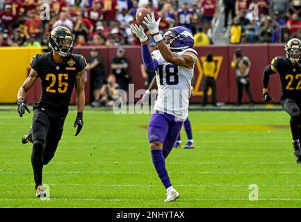 Washington Commanders cornerback Benjamin St-Juste (25) intercepts a pass  intended for Minnesota Vikings wide receiver Justin Jefferson (18) during  the second half of a NFL football game between the Washington Commanders and