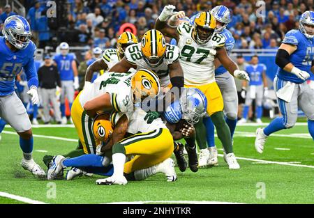 DETROIT, MI - NOVEMBER 06: Detroit Lions running back D'Andre Swift (32)  cuts a run outside and is tackled by Green Bay Packers cornerback Eric  Stokes (21) Green Bay Packers defensive end