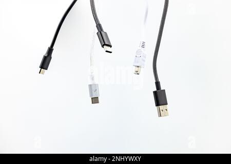 Jumble with many cables, USB plugs and standards isolated against a white background Stock Photo