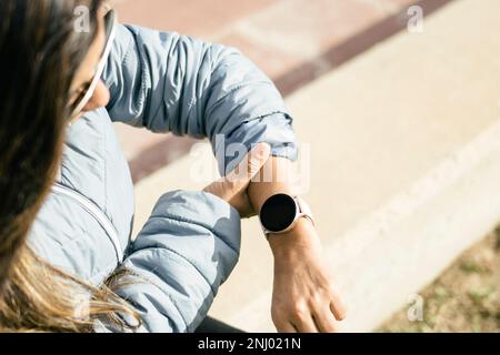 Latina Woman Checking Heart Rate on Smart Watch Stock Photo