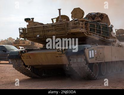 U.S. Soldiers assigned to 1st Battalion, 18th Infantry Regiment, 2nd Armored Brigade Combat Team, 1st Infantry Division stage a M1 Abrams tanks through a Tactical Assembly Area during Decisive Action Rotation 22-09 at the National Training Center, Fort Irwin, Calif., Aug. 3, 2022. Stock Photo