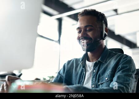 Happy young male customer support executive working in office Stock Photo
