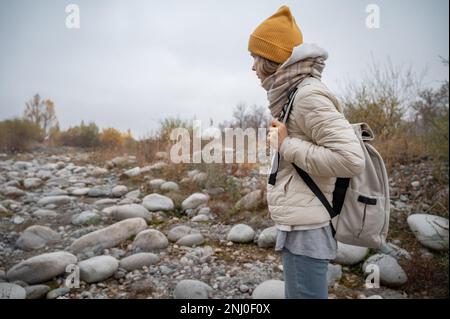 Slow and not deep mountain river with rounded stones Stock Photo