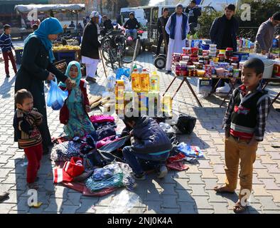 OVAKENT,HATAY,TURKEY-DECEMBER 10:Unidentified  Afghan Woman buying Clothes at  Farmers Market. December 10,2016 in Ovakent, Hatay, Turkey Stock Photo