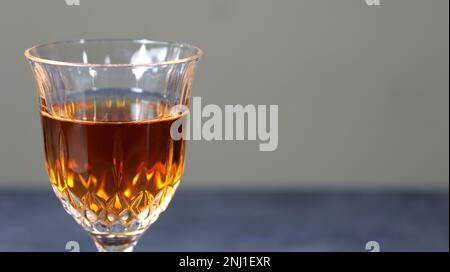 https://l450v.alamy.com/450v/2nj1exr/a-closeup-of-a-glass-of-brown-cocktail-on-a-gray-background-2nj1exr.jpg